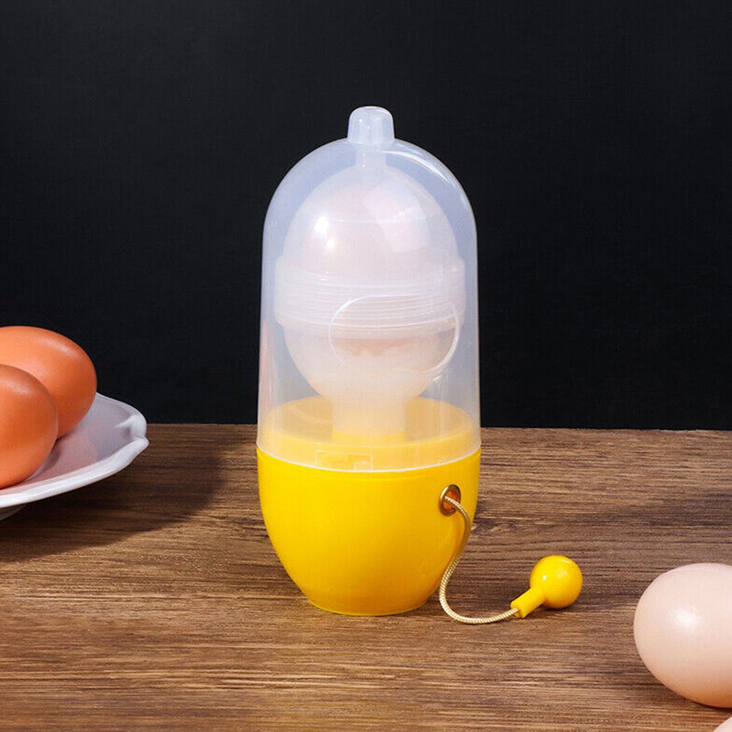 Kitchen countertop scene featuring the Manual Egg Scrambler alongside fresh eggs, ready for use.