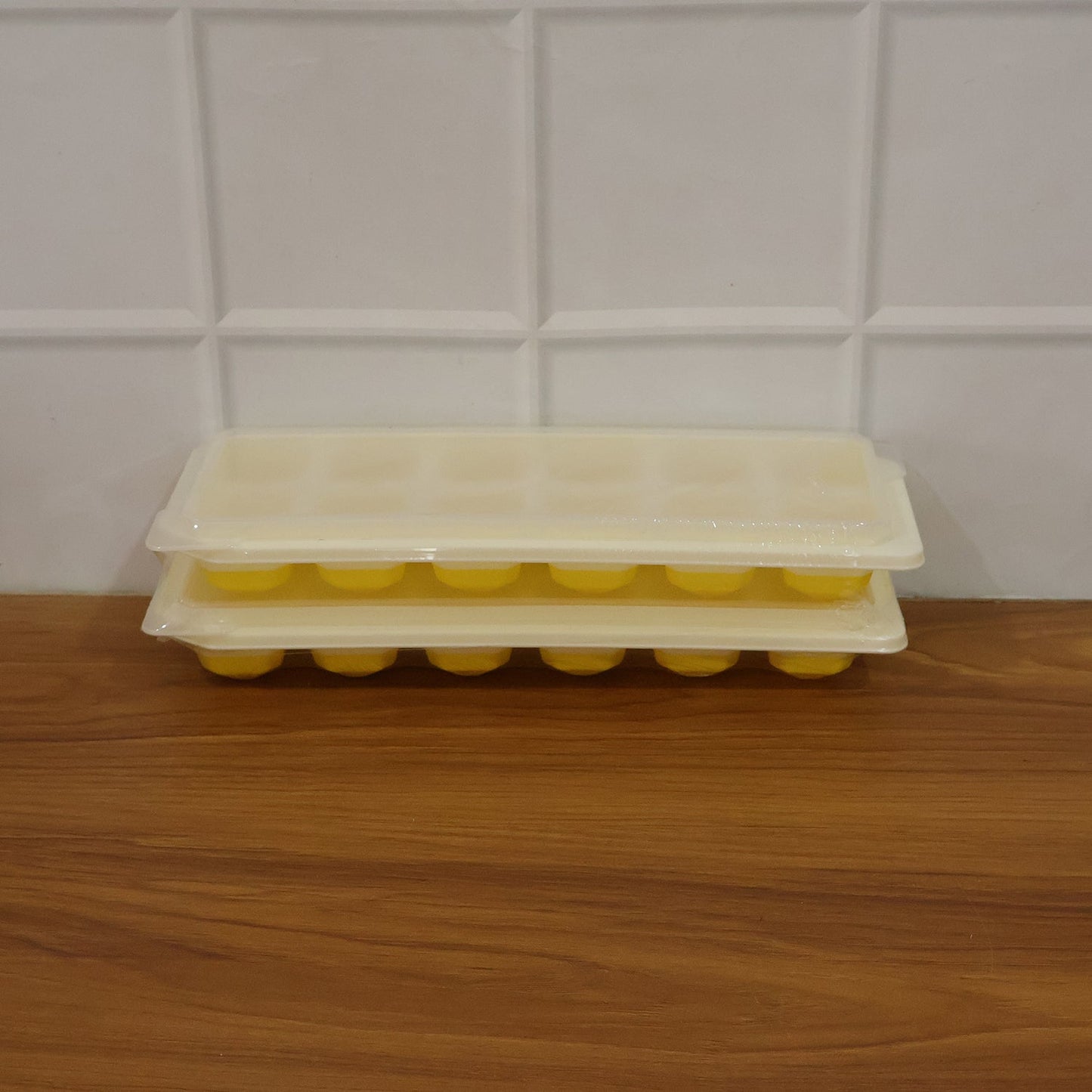 Easy release silicone ice cube maker with 24 compartments and lid.