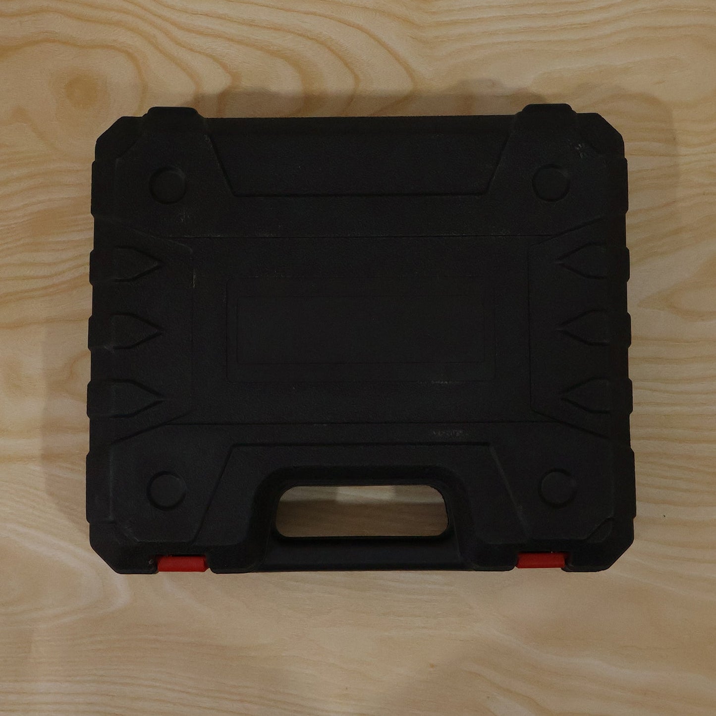 Cordless drill tool kit case on wood surface