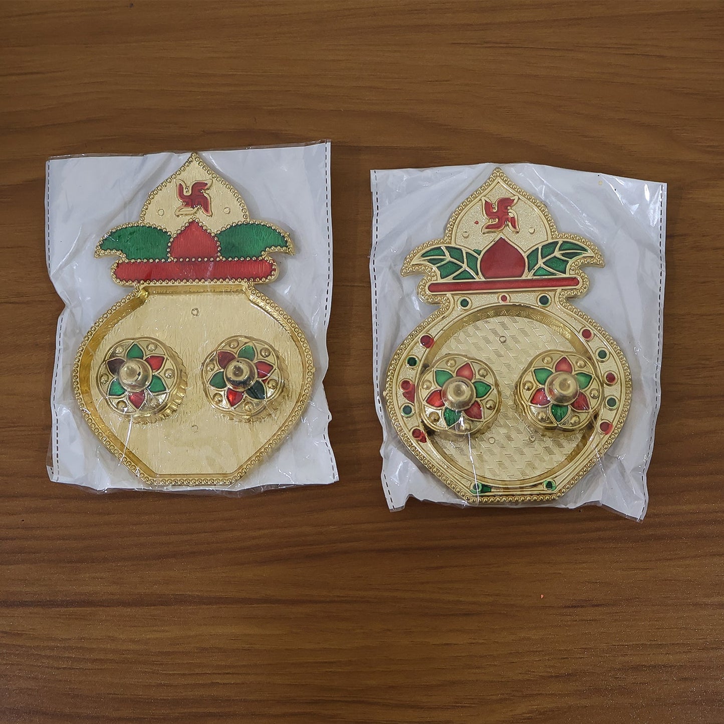 Multiple decorative Kalash-shaped kumkum boxes in assorted festive designs