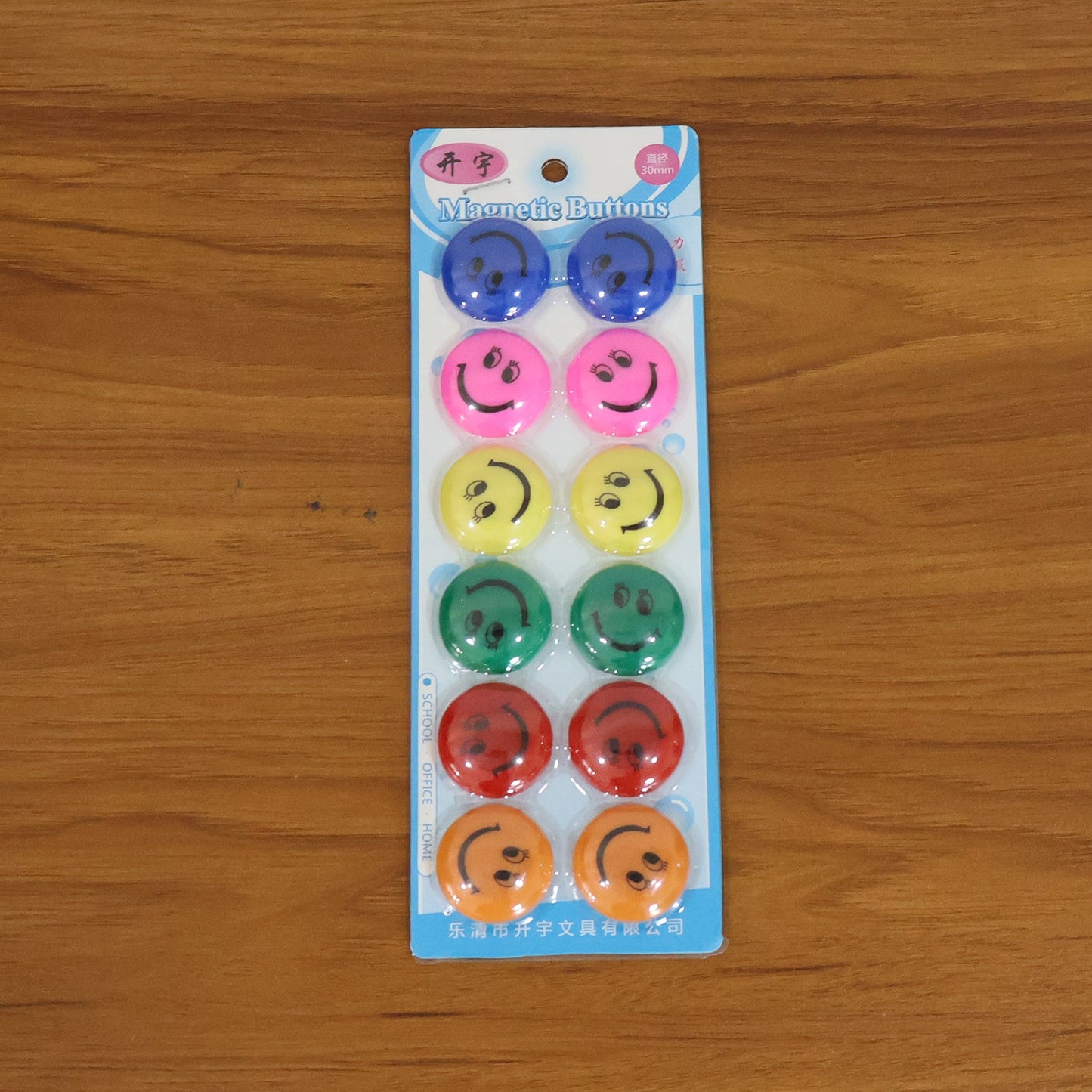 Multicolored smiley face magnetic buttons arranged in set