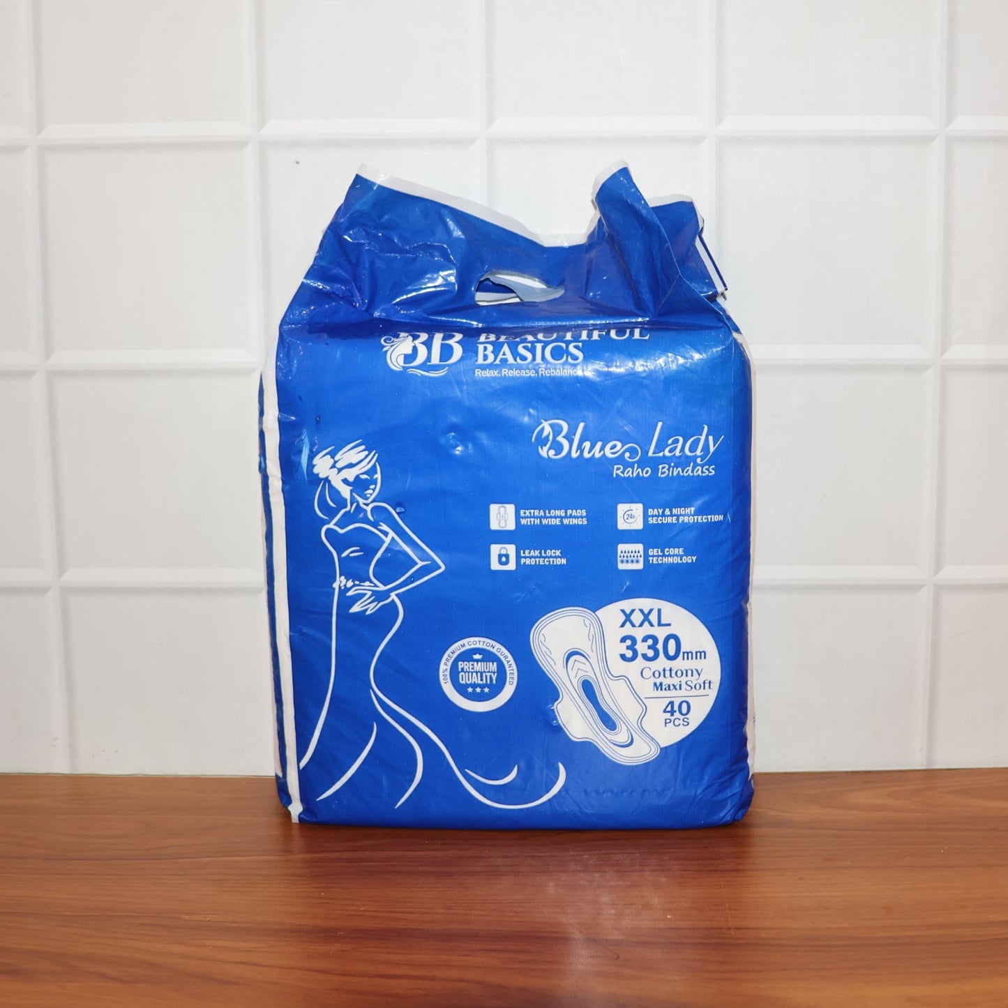 A pack of Sanitary Pads 330mm next to a single pad, showcasing both the product and its packaging.