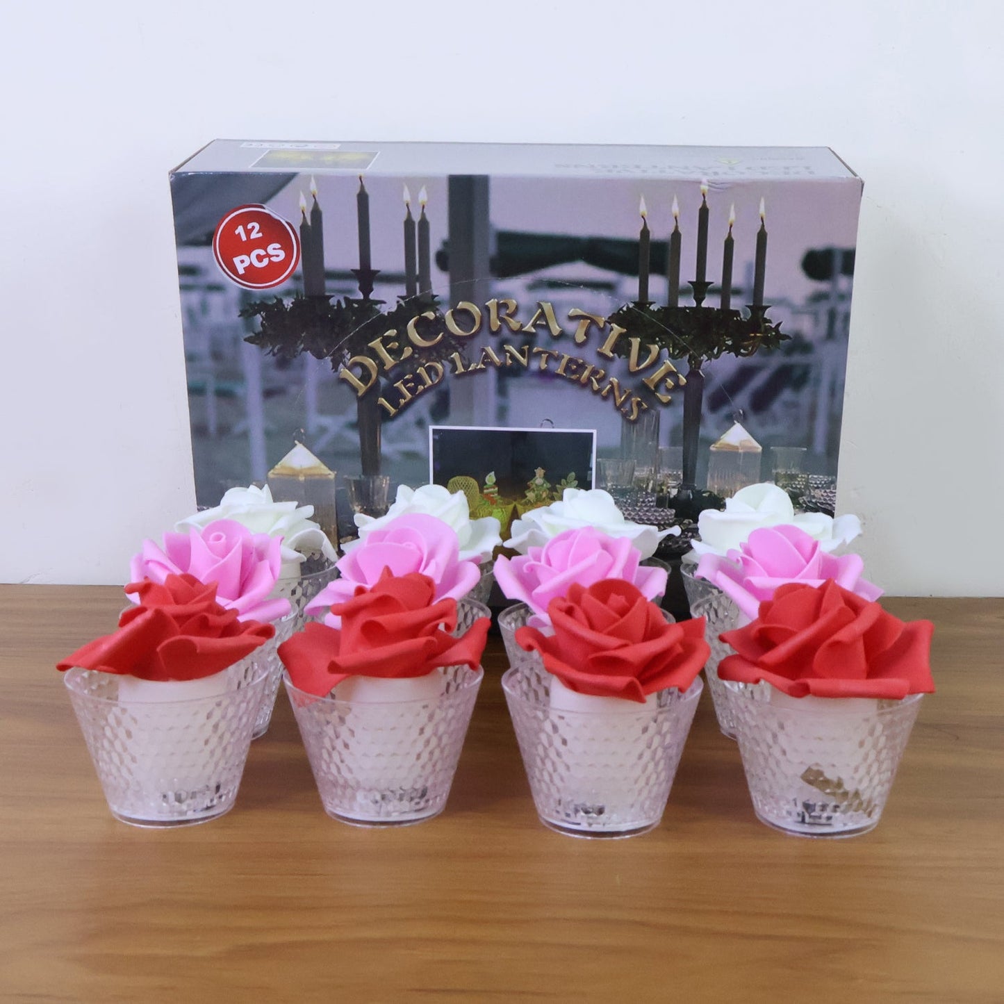 Close view of artificial rose on top of flameless decorative LED candle
