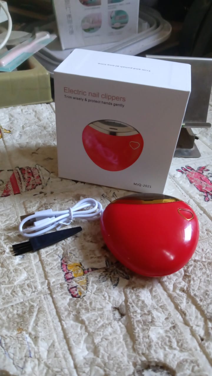 Compact electric nail clipper placed on a clean surface ready for use