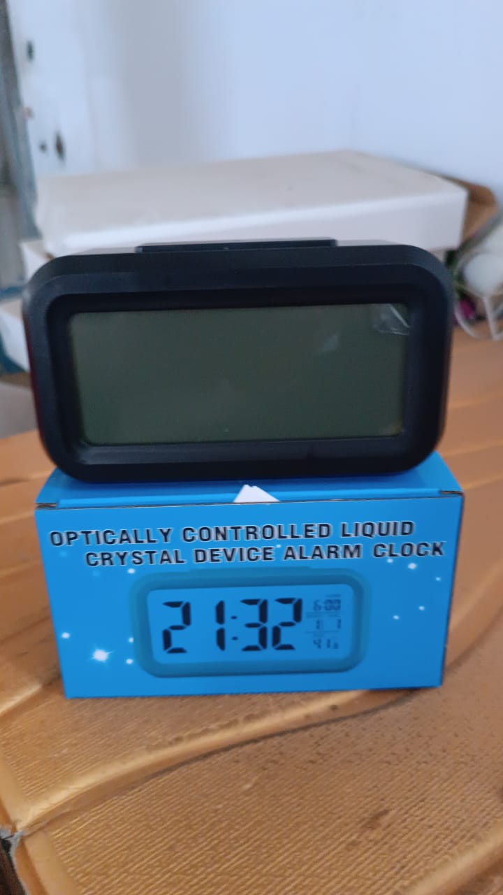 digital LCD alarm clock with backlight in lifestyle table setup