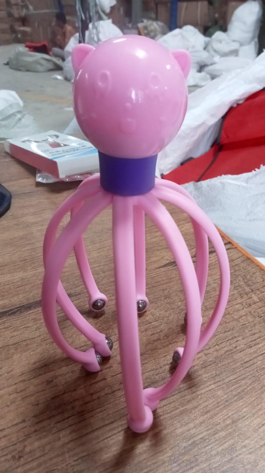 Octopus-shaped electric scalp massager presented on a clean background.