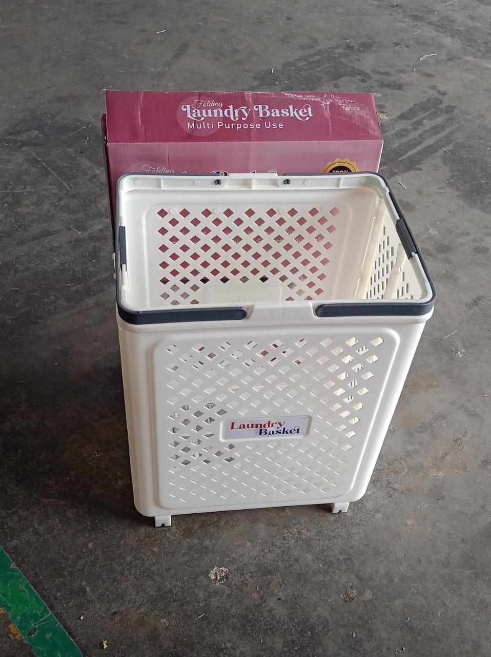 Foldable laundry basket being used to carry laundry with wheels