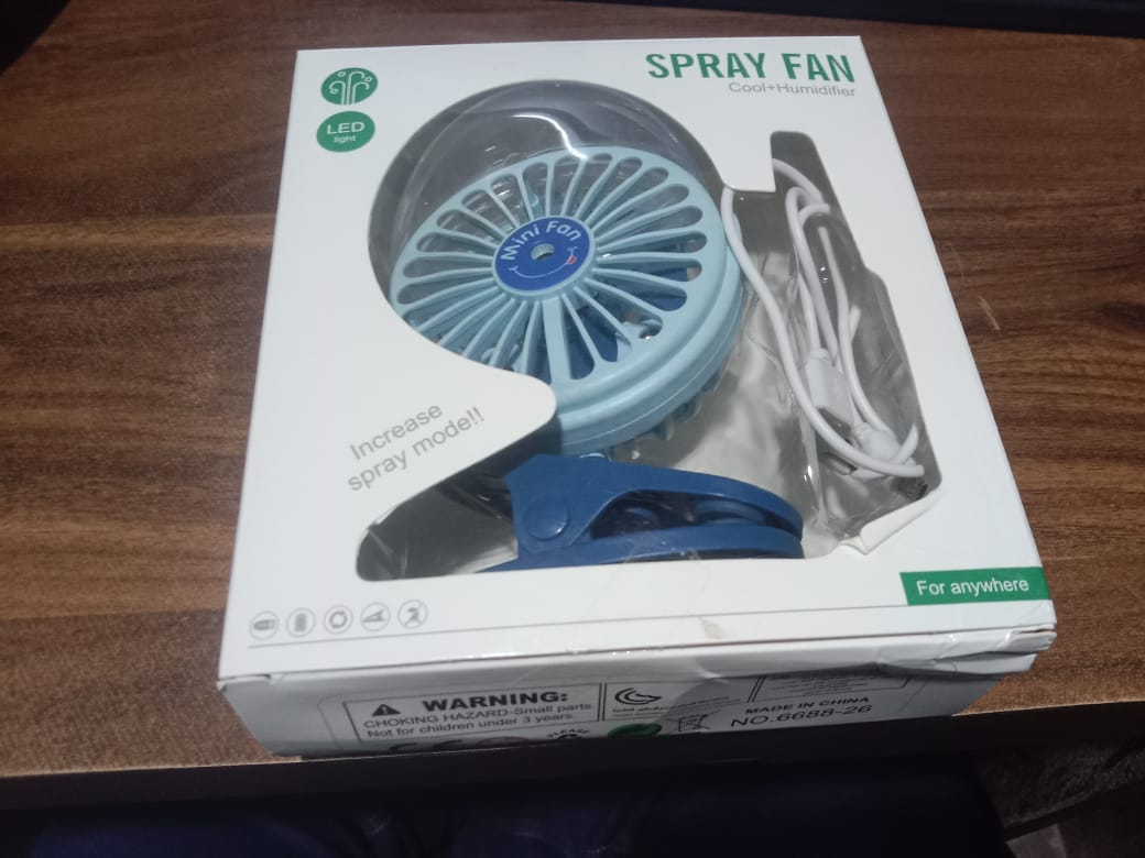personal cooling fan with its USB charging cable, ready for use.