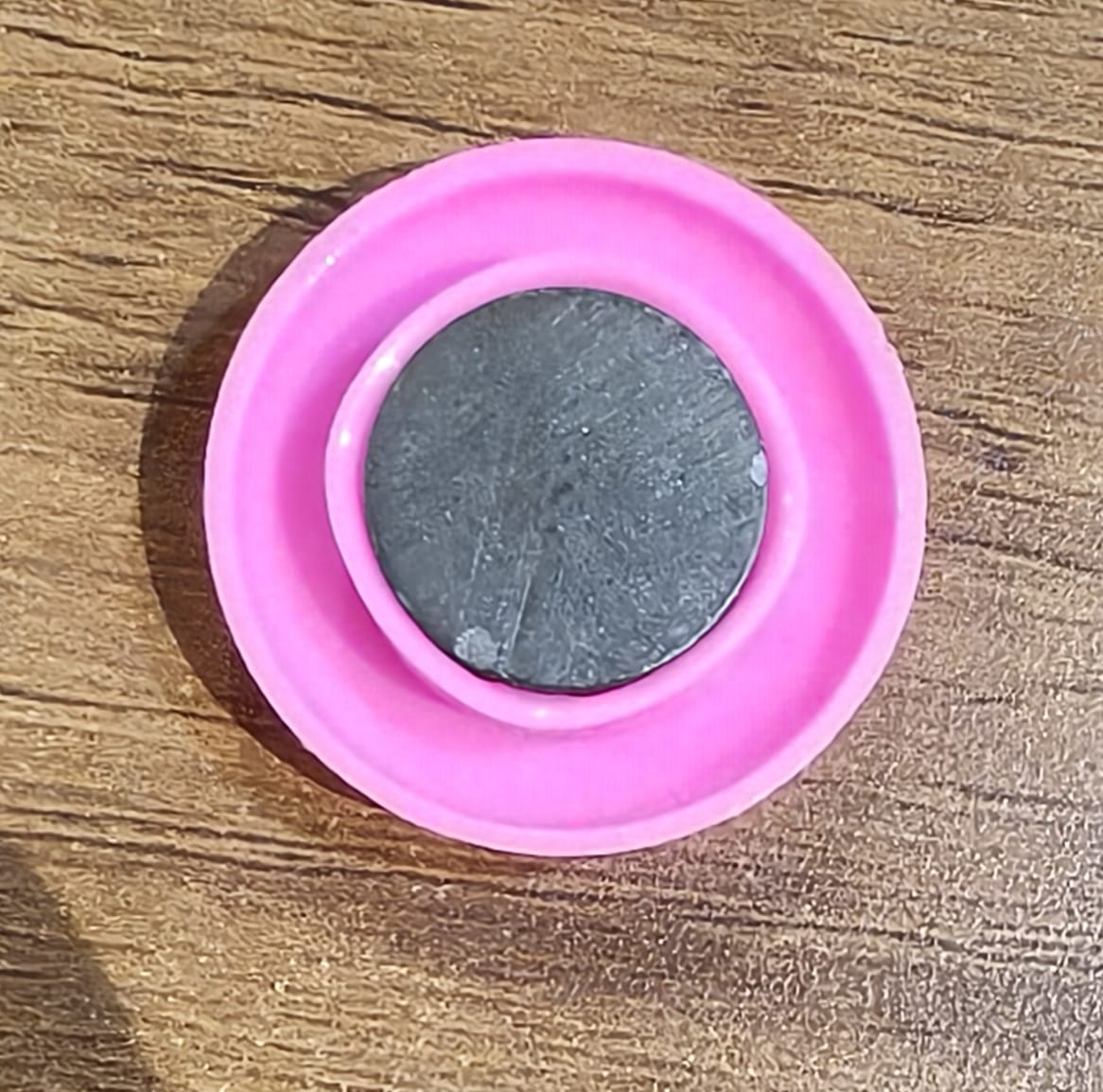 Multiple views of pink board magnet button showing size and colour