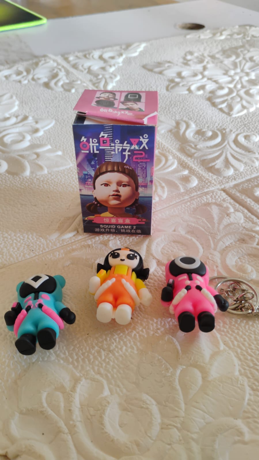 Flexible silicone character keychain secured by metal ring