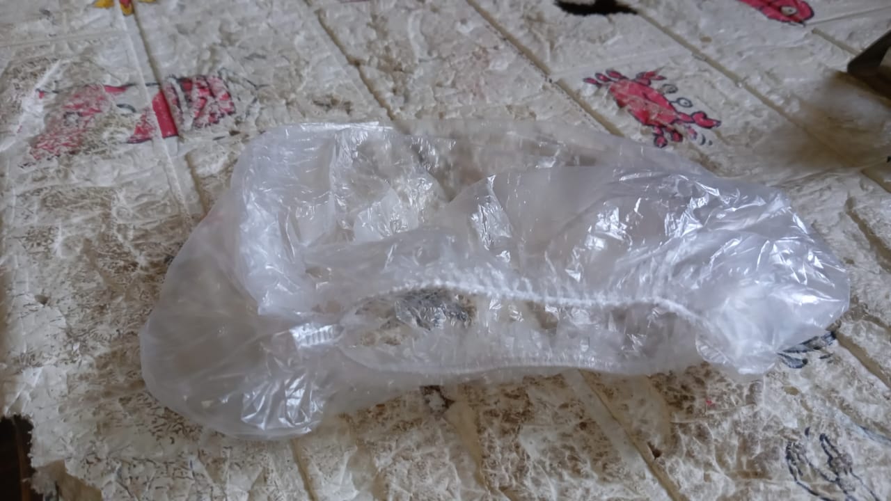 A VelvaBloom disposable shower cap fitted on a mannequin head, showing its universal fit.