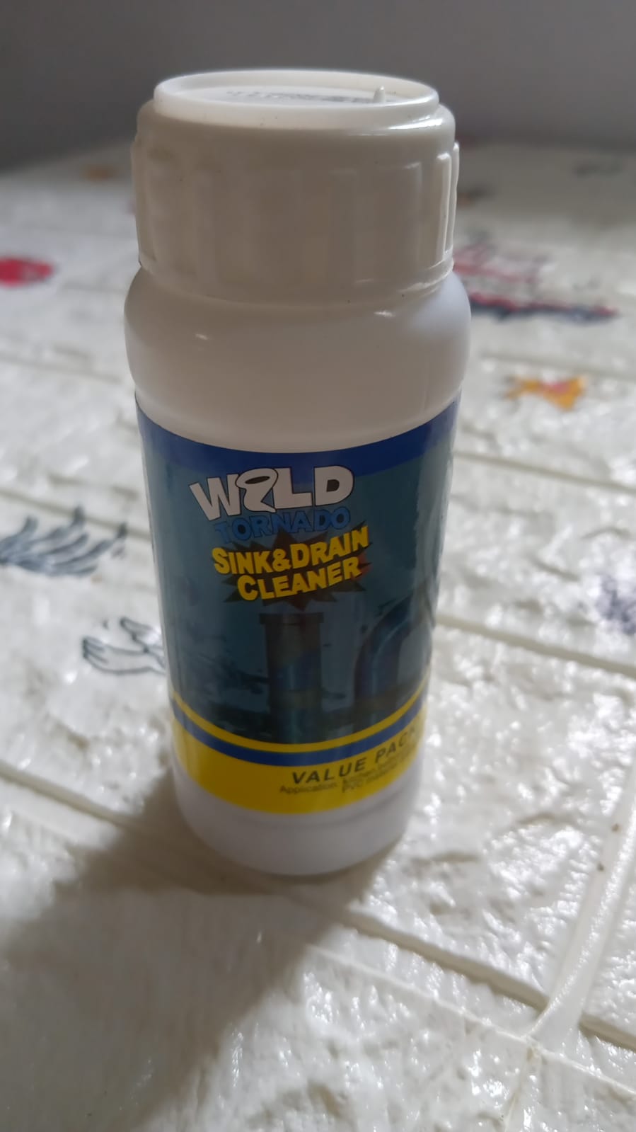 Drain cleaning powder effectively removing blockages from a kitchen sink.
