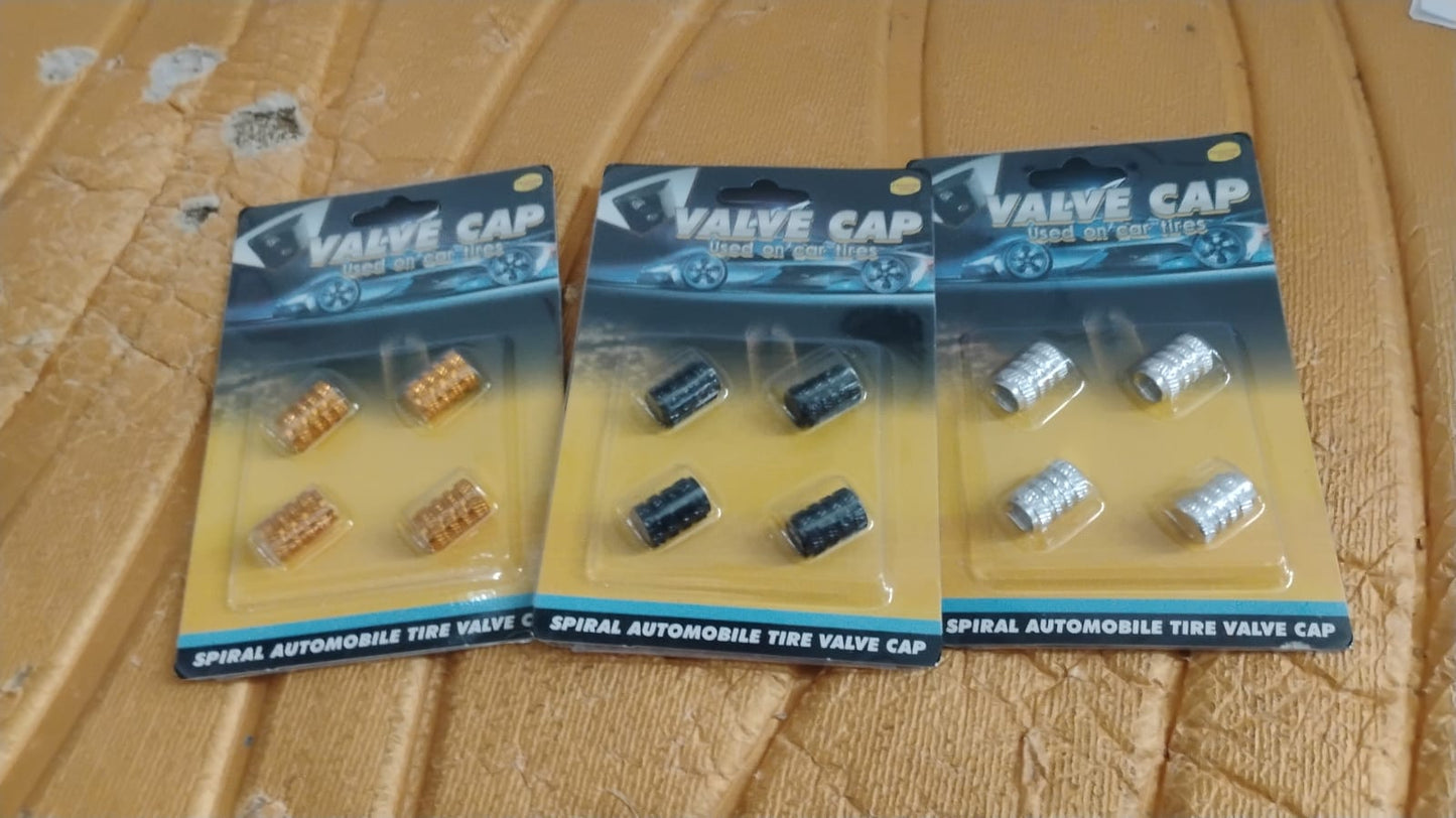 Silver aluminium valve stem cap resting on smooth surface