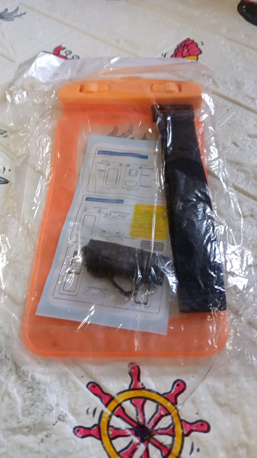 A user taking an underwater photo with their phone securely sealed in the waterproof pouch.