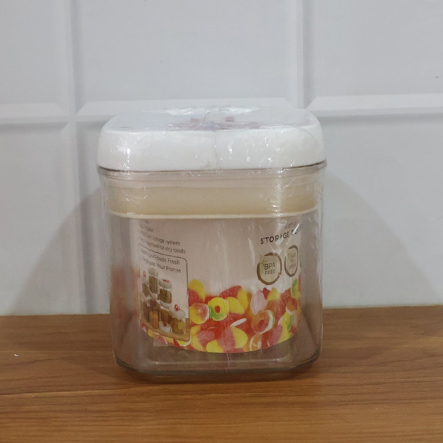 Transparent airtight jar with vibrant red lid for snacks
