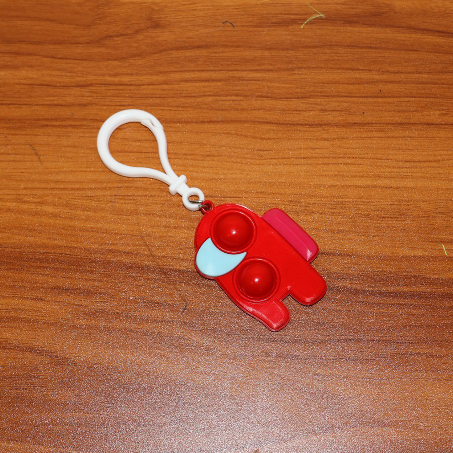 Lifestyle shot of a Pop-It Fidget Keychain being used by someone, emphasizing its role as a calming sensory toy.