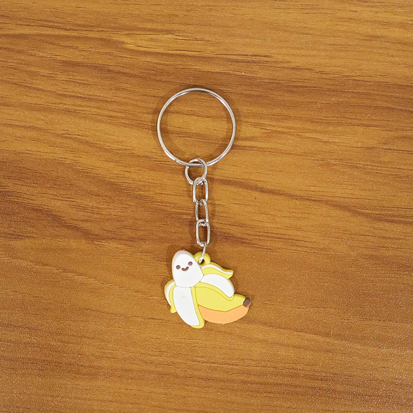 Close view of banana cartoon keychain charm with metal key ring accessory