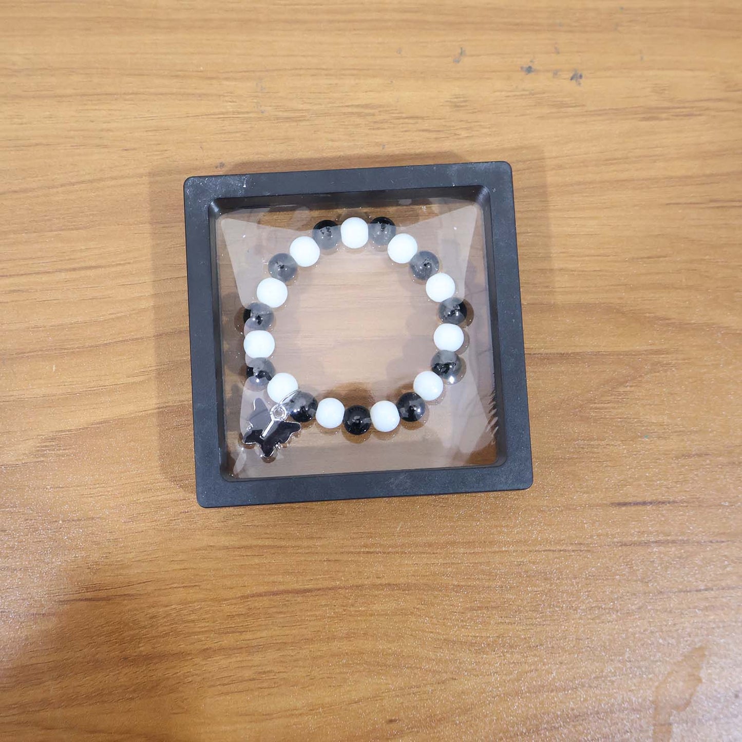 Elegant black and white beaded bracelet worn as fashion accessory