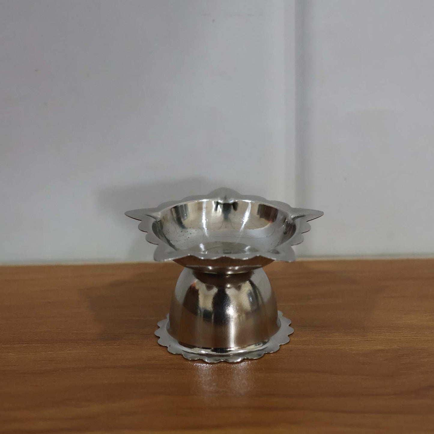 Silver-toned stainless steel sunflower diya for pooja and aarti rituals
