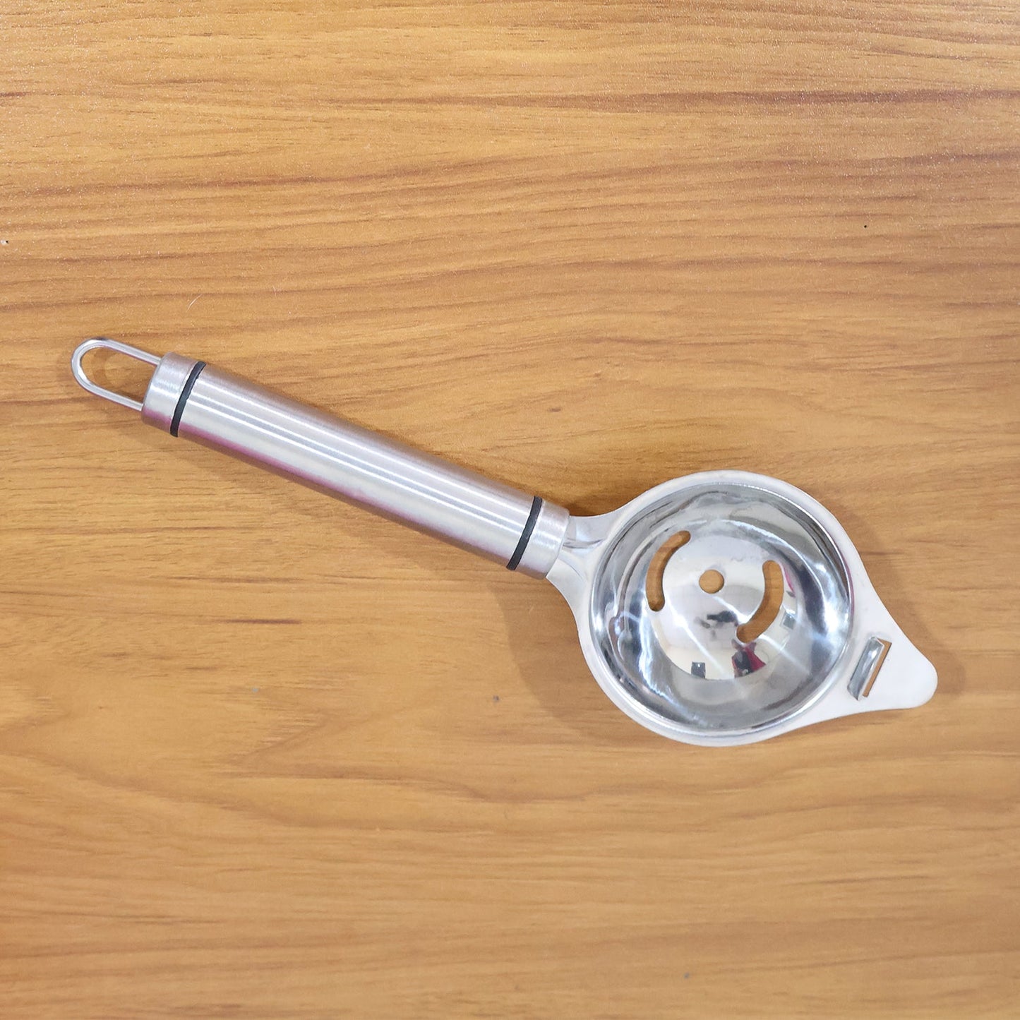 Stainless steel egg separator displayed with clean, shiny finish