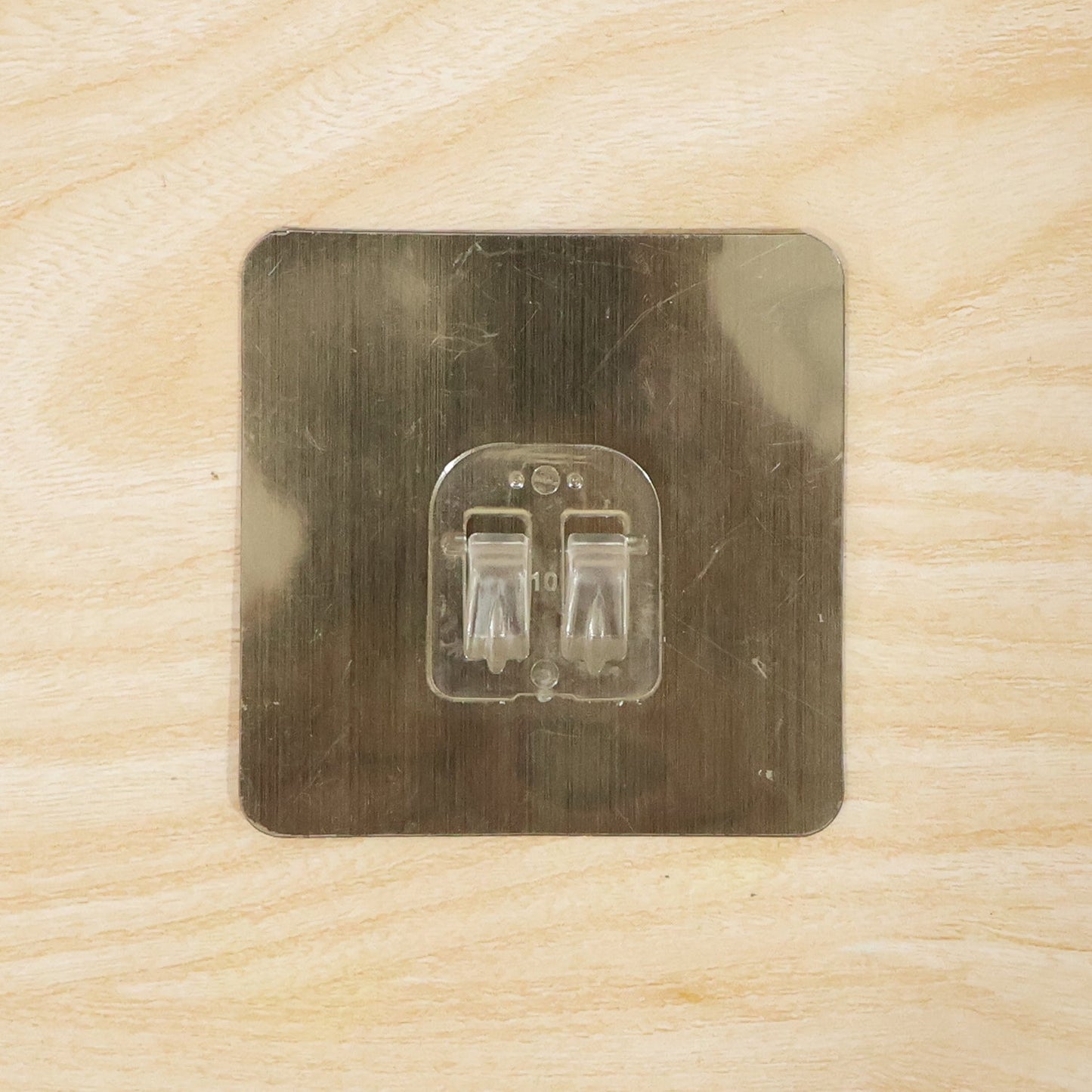 Adhesive wall hook on metal surface for home organization