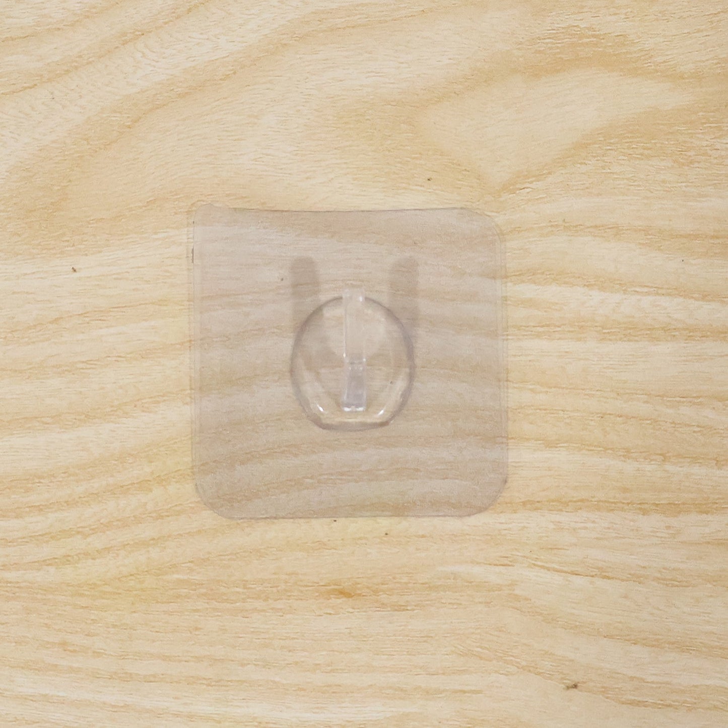 Wall hook on wooden door with transparent adhesive