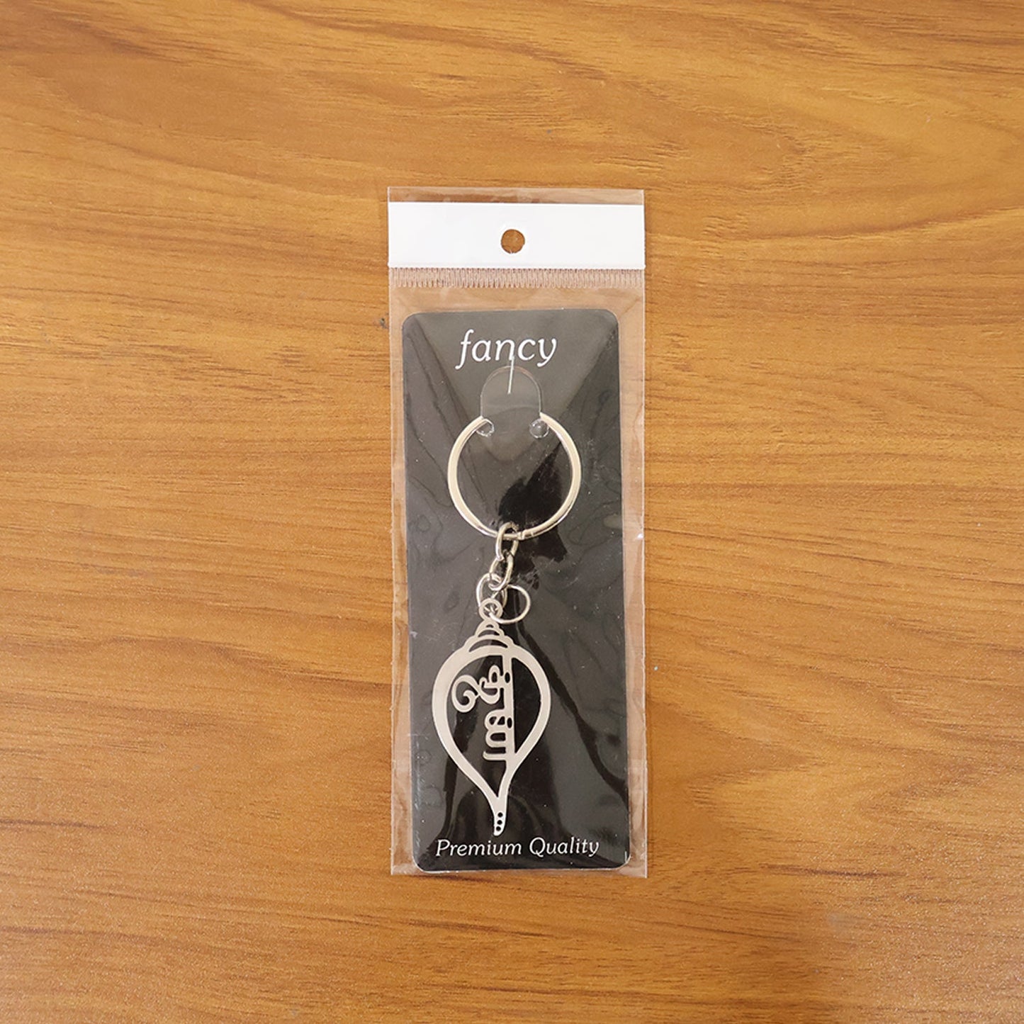 Metal Krishna symbol keychain, perfect for daily keys