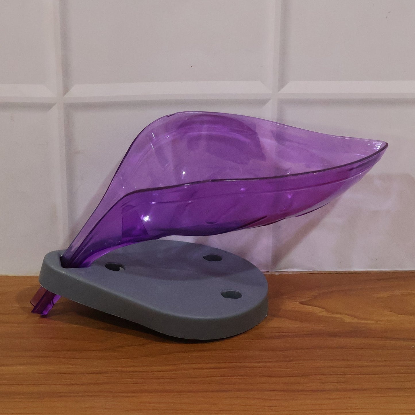 Empty leaf-shaped soap tray ready for use in a bathroom.