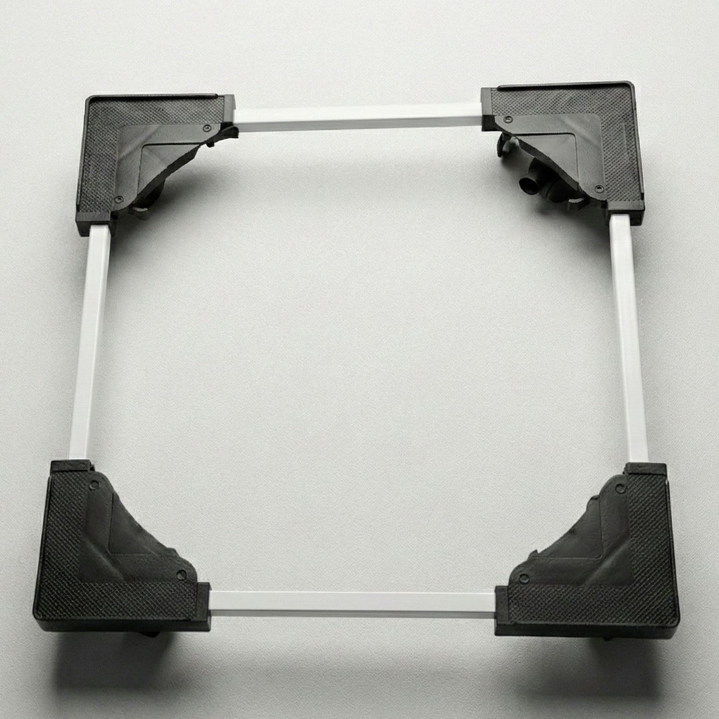 Adjustable appliance stand elevating a washing machine in a laundry area