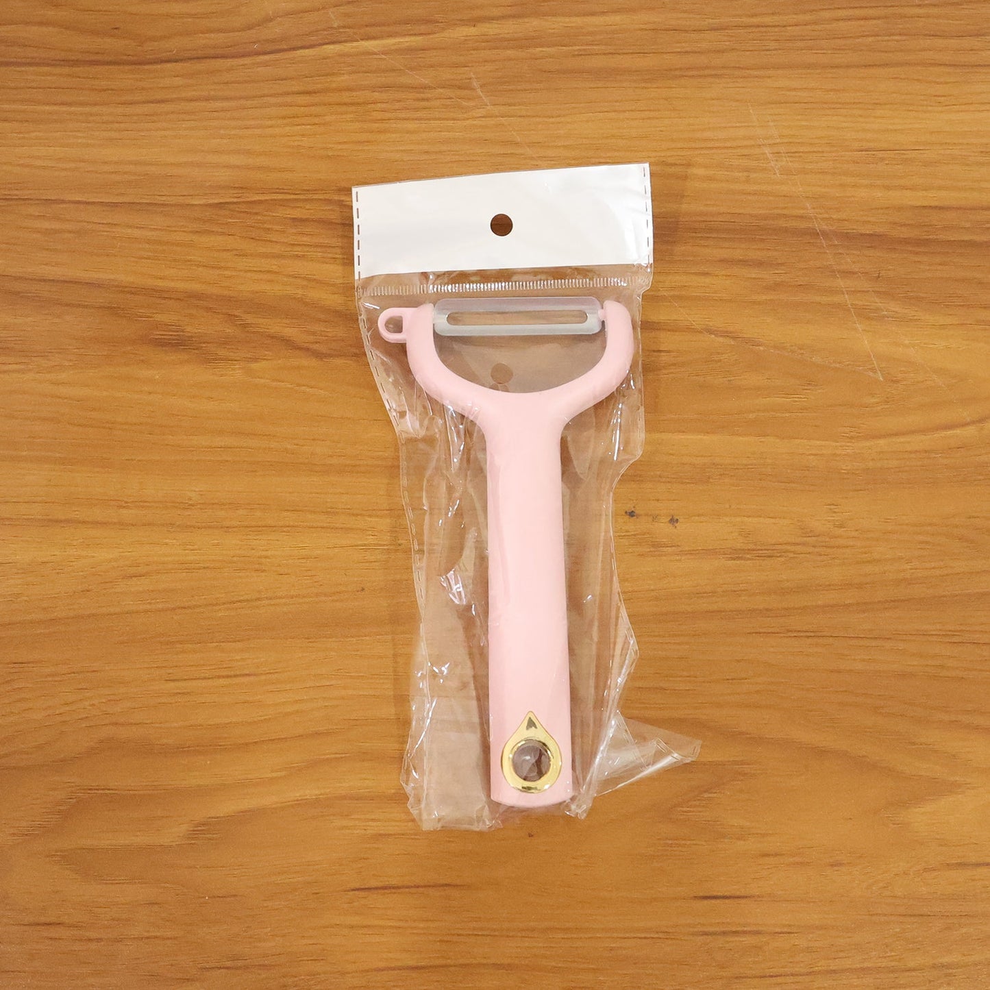 Ergonomic vegetable peeler in use peeling fresh fruits and vegetables smoothly