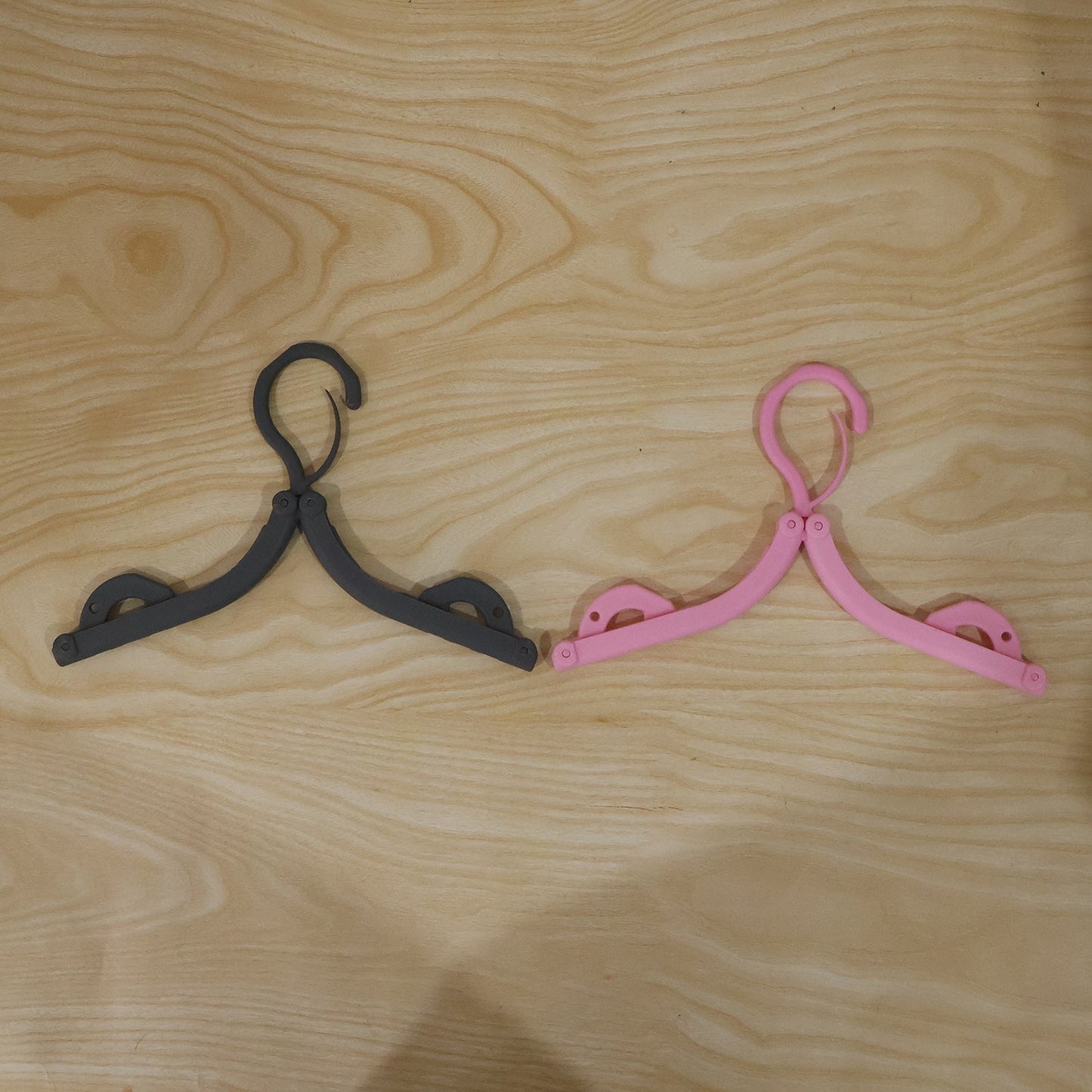 Bright colored foldable hanger designed for organizing wardrobe efficiently