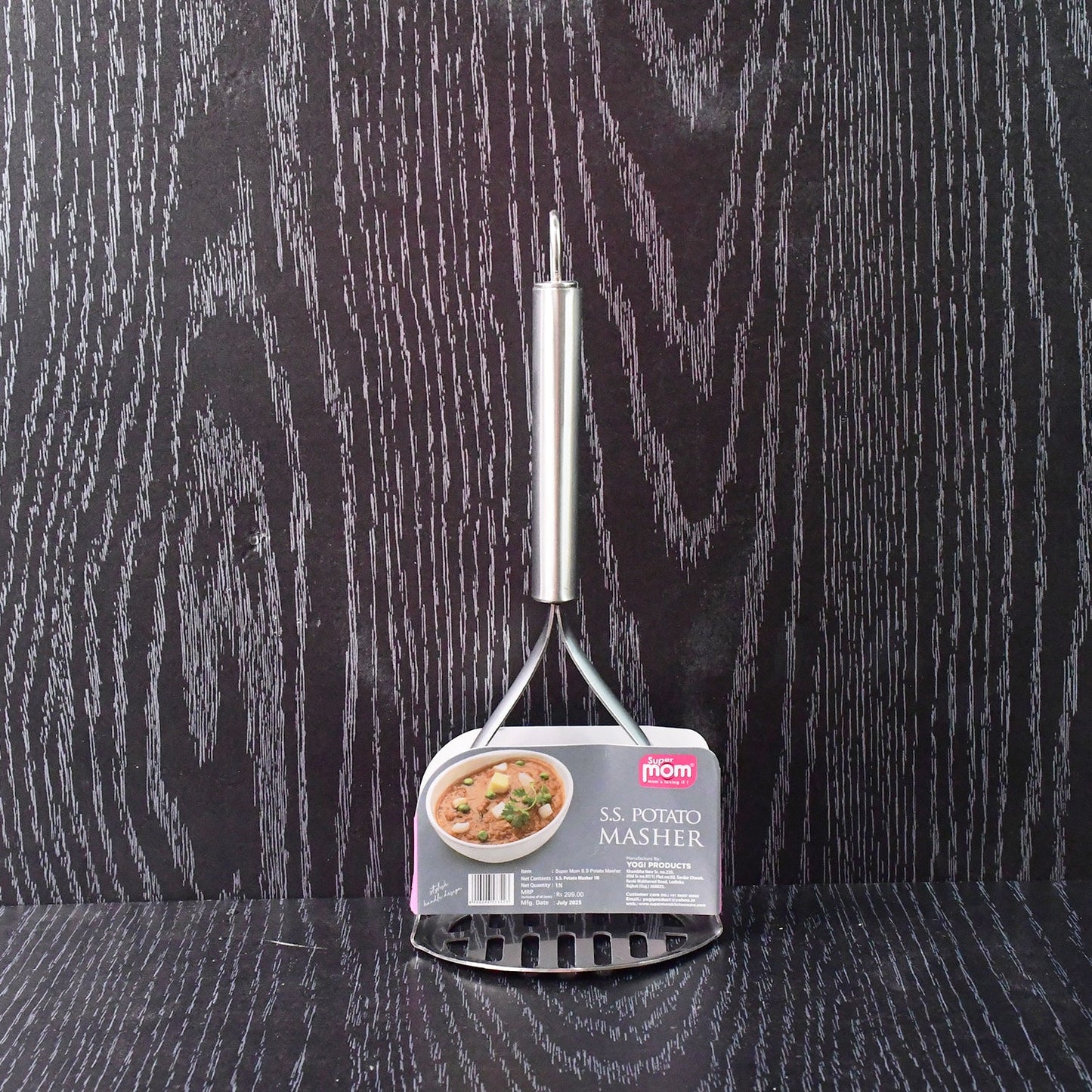 Potato masher in kitchen environment with ergonomic handle