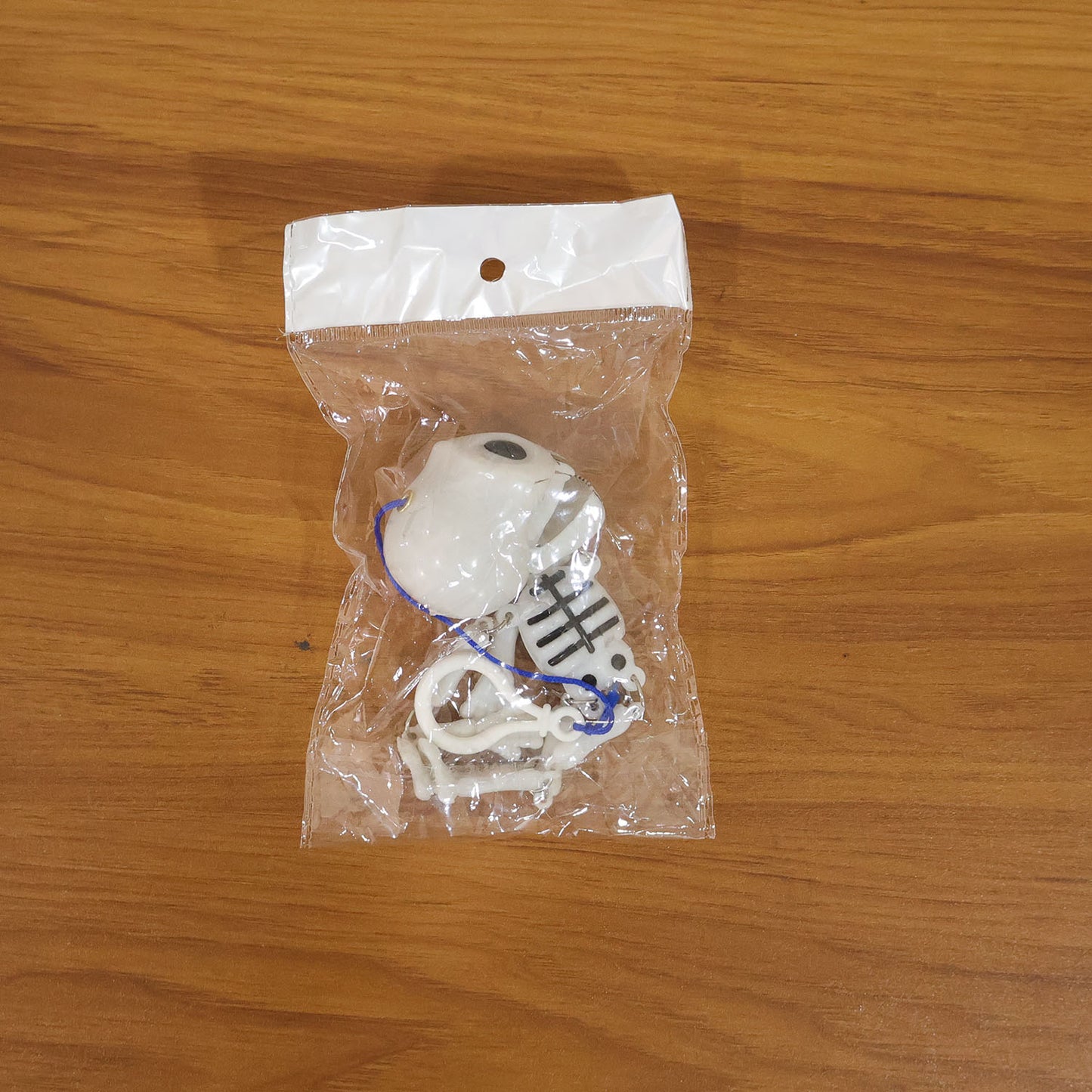 Skeleton doll keychain displayed as quirky bag charm