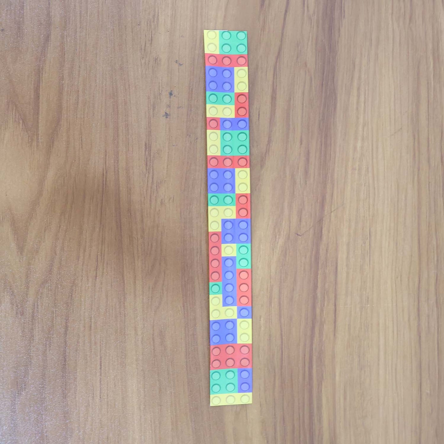 Child wearing colorful snap slap bracelet toy on wrist