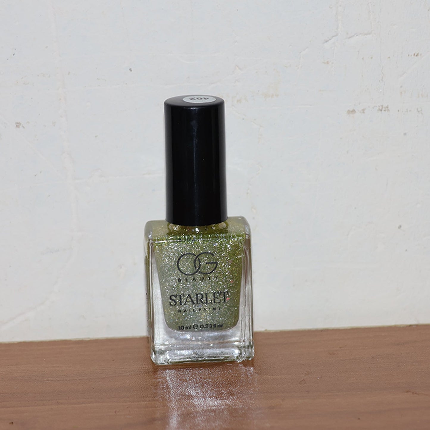 Starlet glitter nail paint shimmering on nails in Sunshine Gold shade