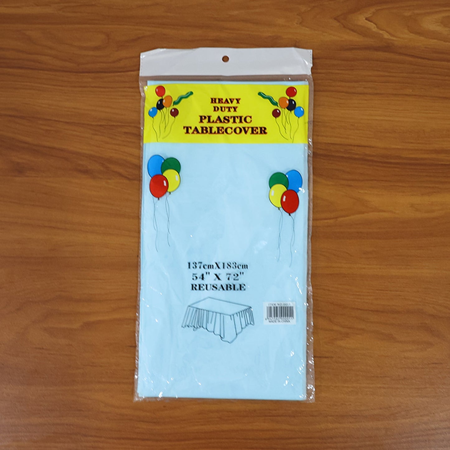 Disposable plastic table cover spread fully on rectangular table