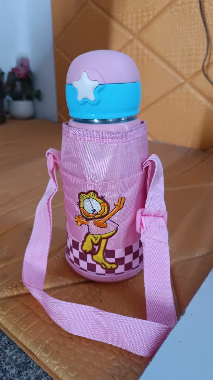 Thermos kids water bottle with cover and strap placed on table