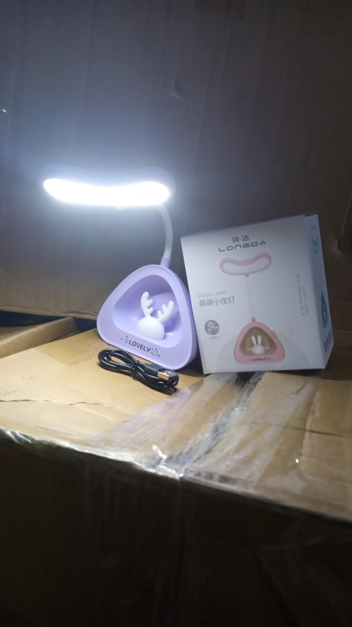 Compact LED desk light with button control on a clean workspace.