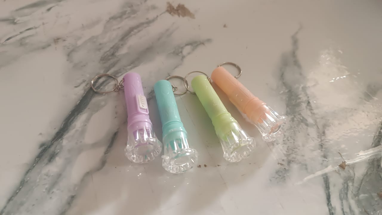 Close-up view of Mini LED Keychain Torch showing LED bulb and switch button