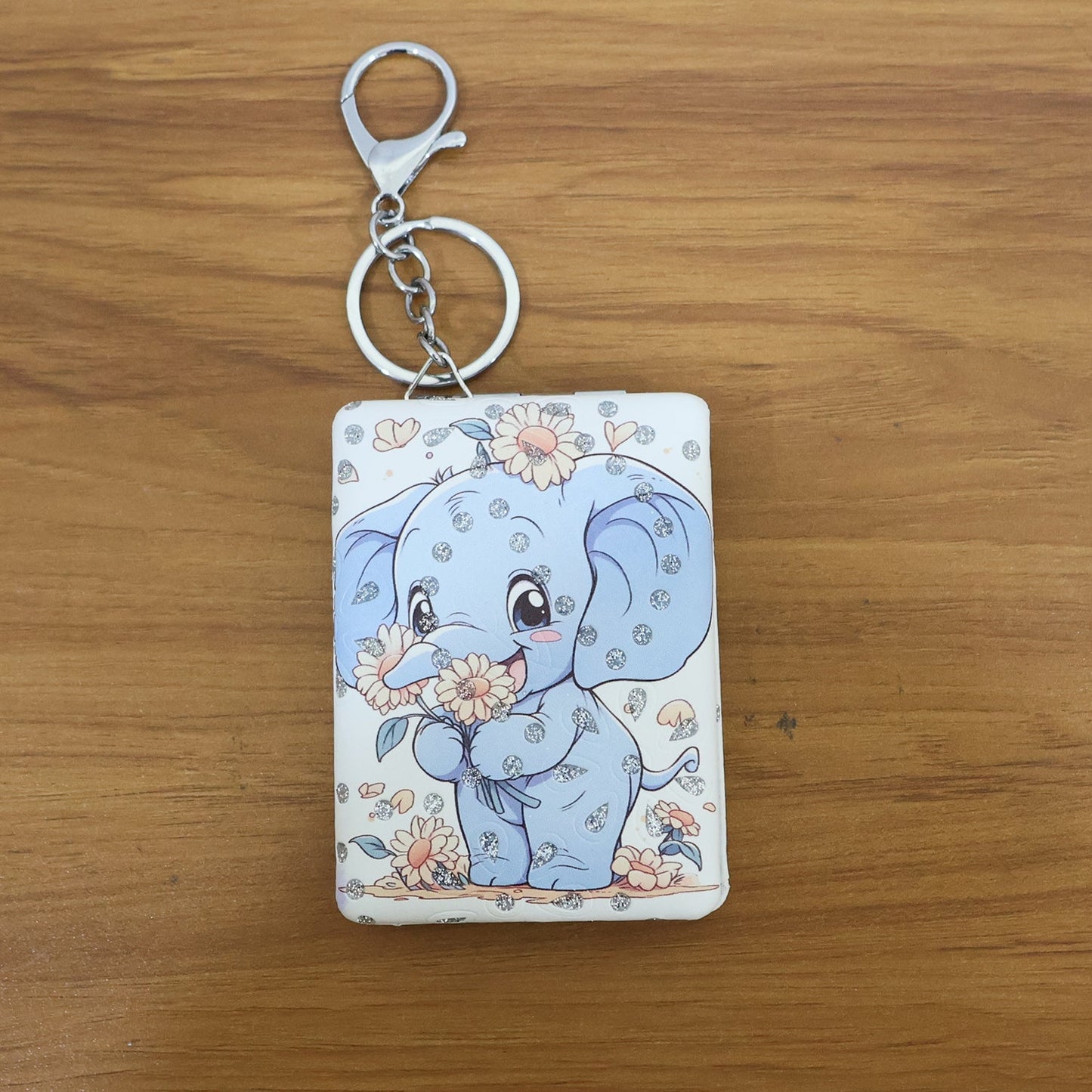Foldable compact mirror keychain closed with elephant design visible