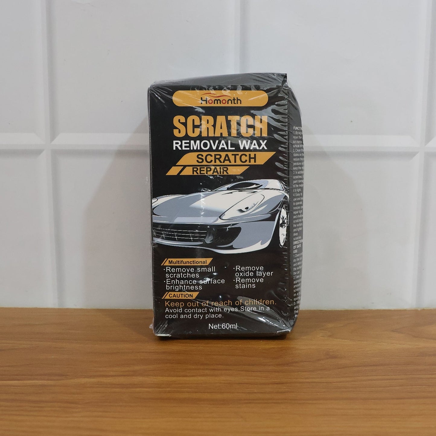 Comparison of car surface before and after using scratch removal wax