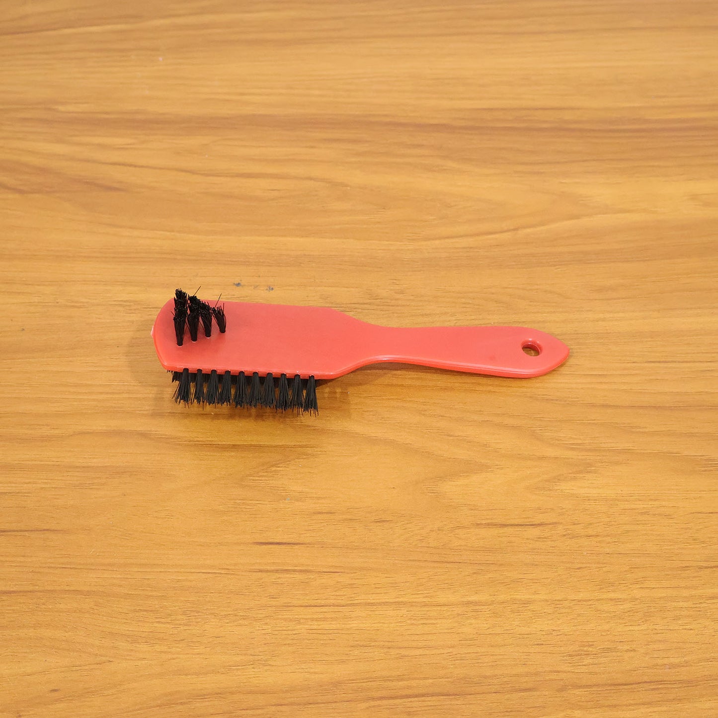 Shoe cleaning brush in use cleaning sneakers to remove dirt and stains