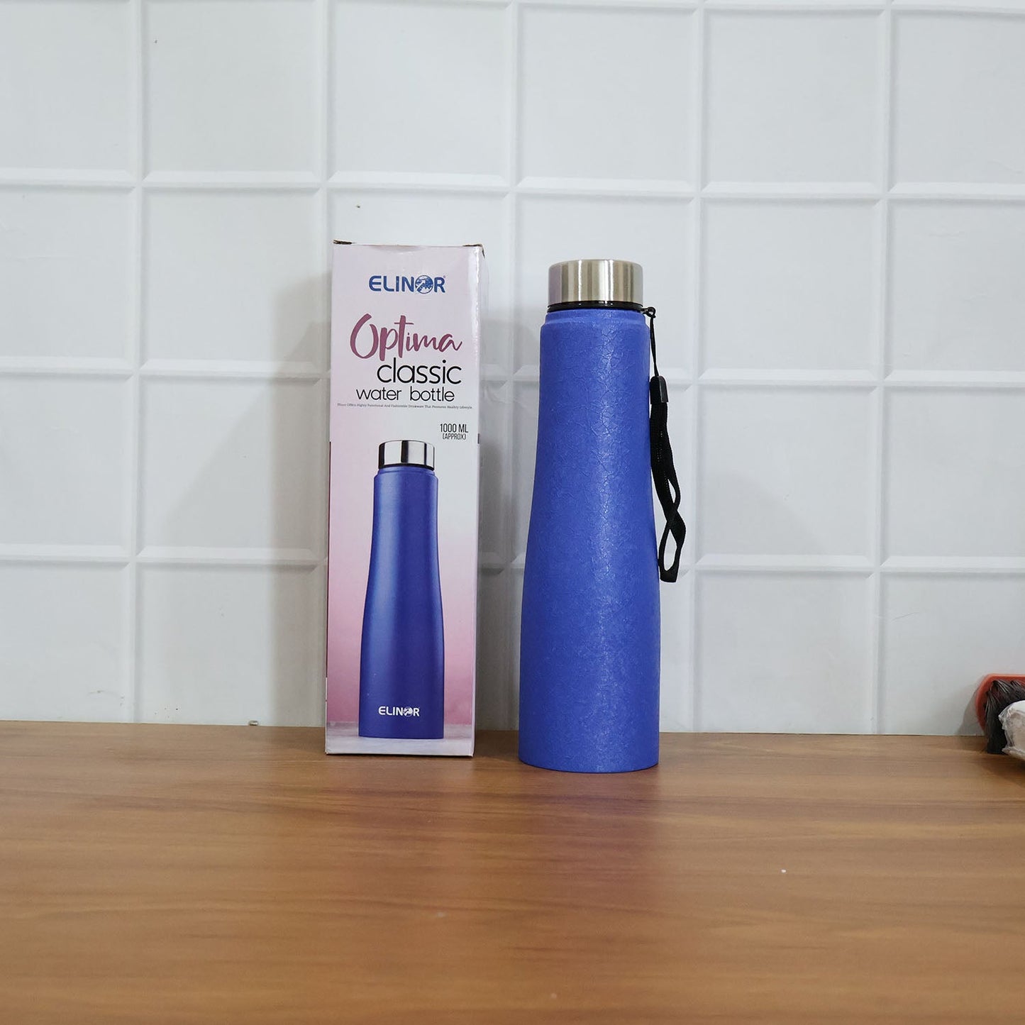 Blue stainless steel water bottle in outdoor fitness setting