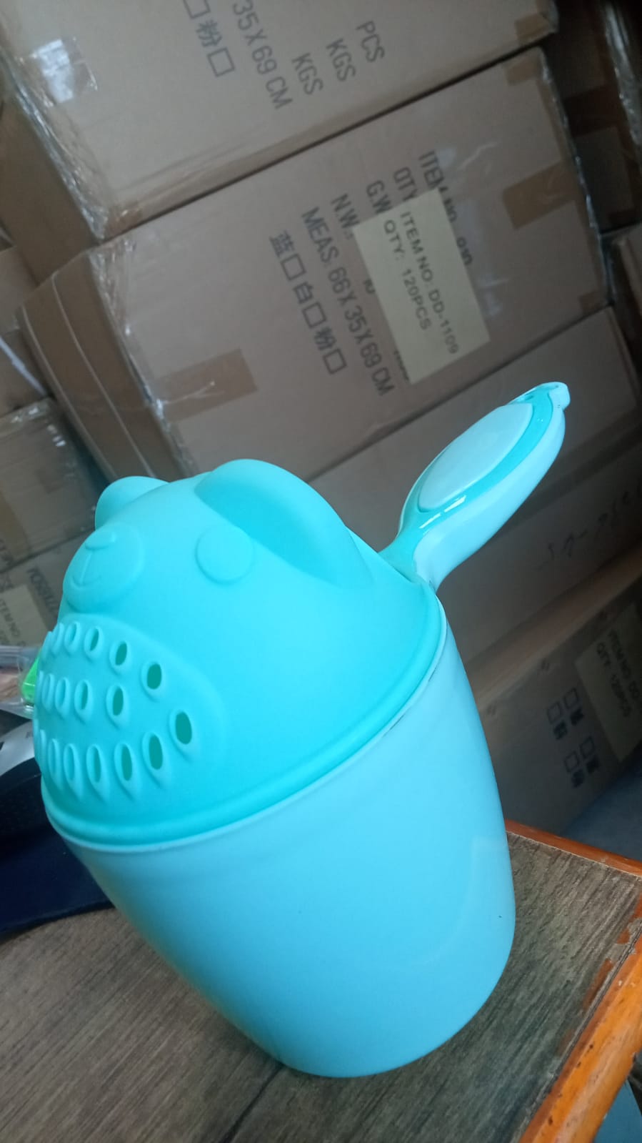 Soft blue Baby Shampoo Shower Cup with playful cartoon accents, designed to make hair washing fun for kids.