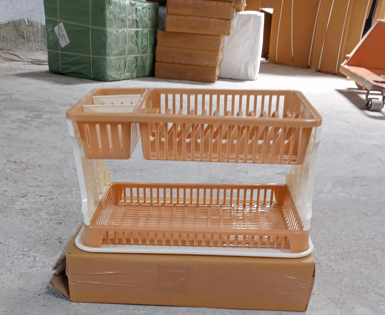 Modern black dish rack with various kitchen utensils draining into a tray.