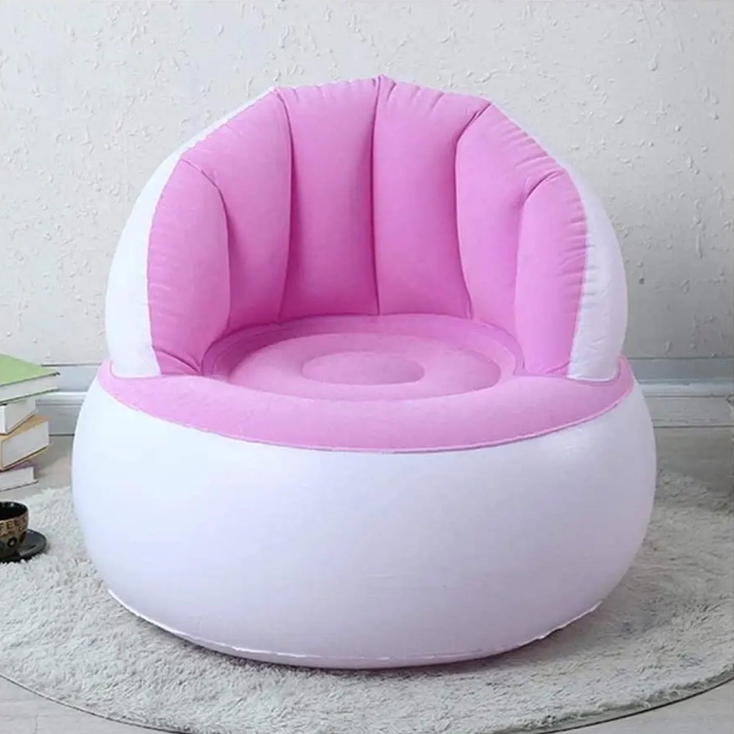 Child happily sitting on a bright yellow Kids Inflatable Sofa Chair with backrest.