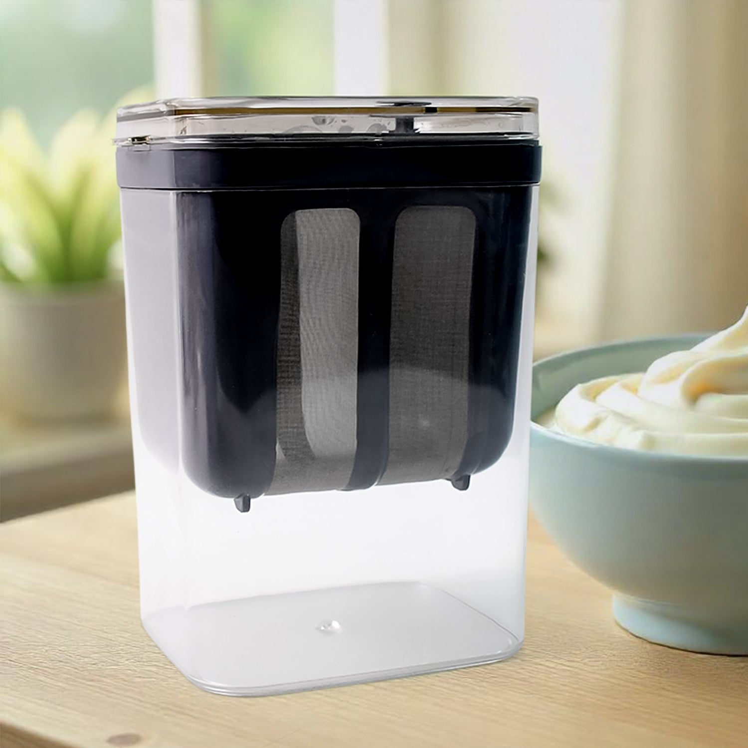 Yogurt strainer with transparent base for easy monitoring of strained yogurt