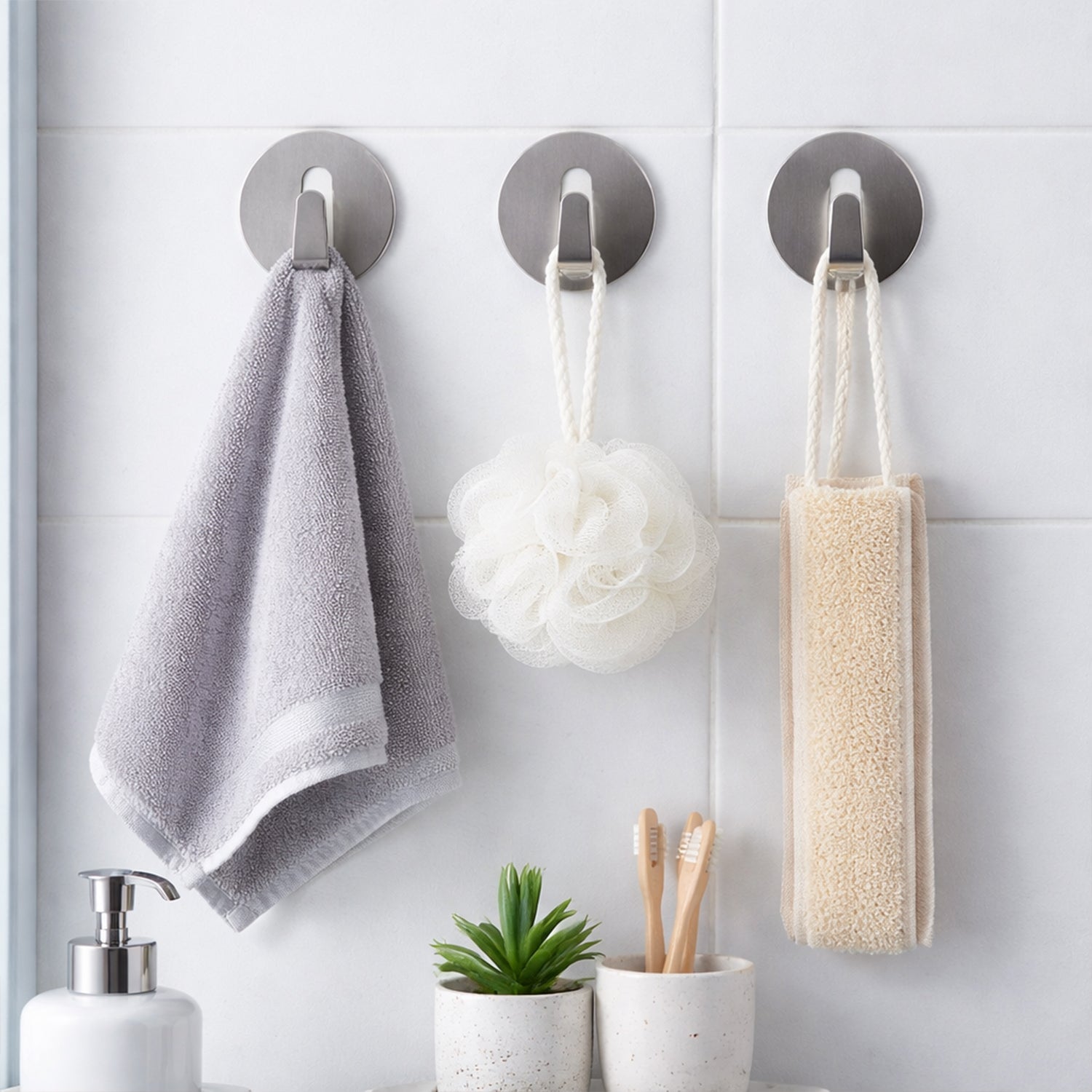 Sleek stainless steel hook securely mounted on a wall, ready for use.