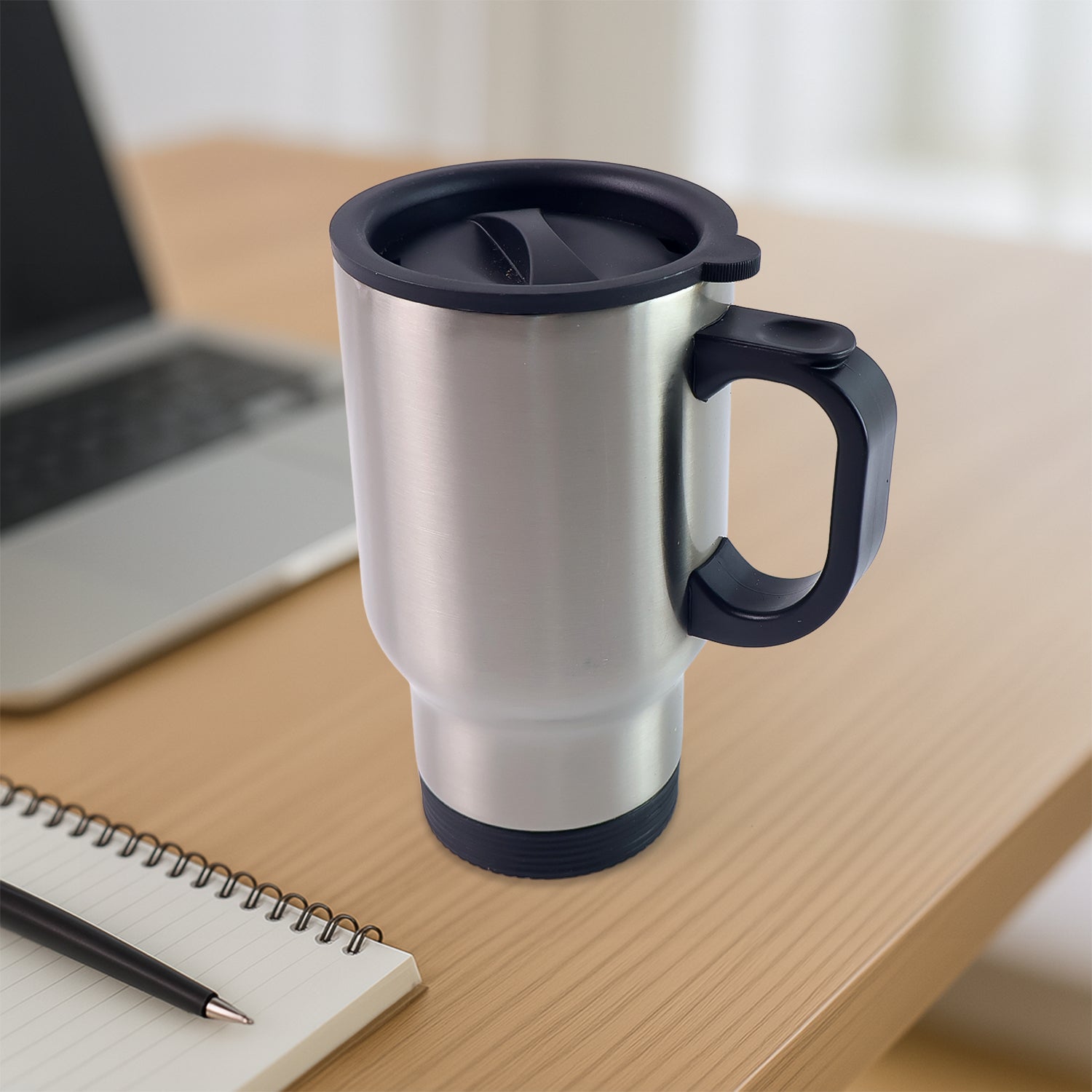 Stainless steel insulated coffee mug with handle and lid, perfect for travel.