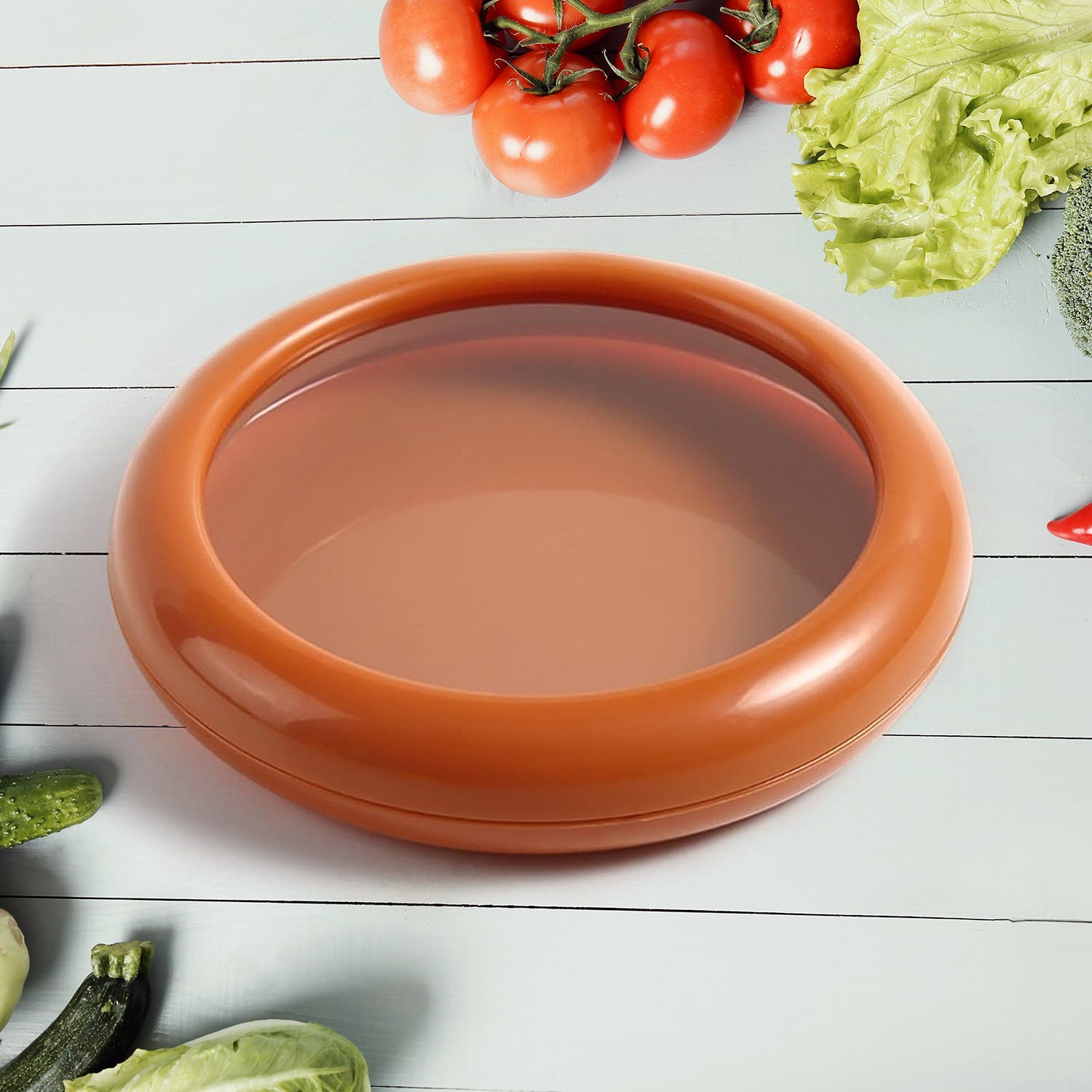 Vegetable & Fruit Saver container, round shape, clear lid, on a kitchen counter.